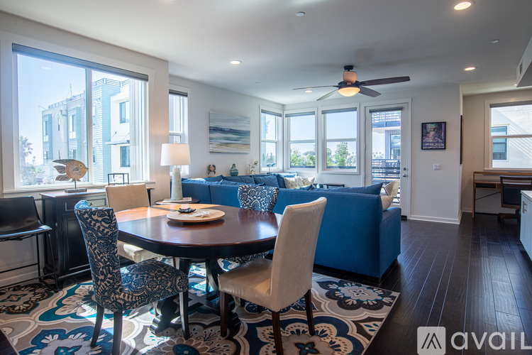 A dining room with a round table and chairs.