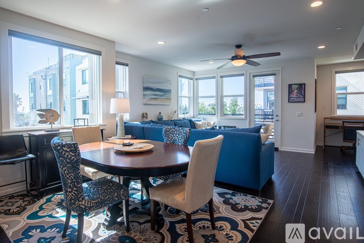 A dining room with a round table and chairs.
