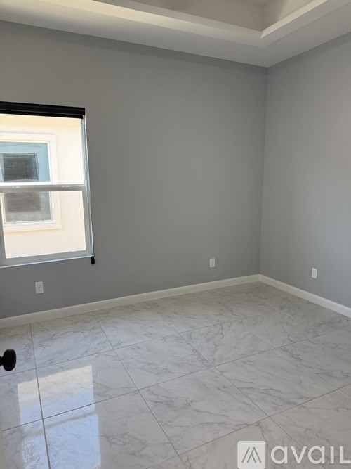A room with a marble floor and a window.