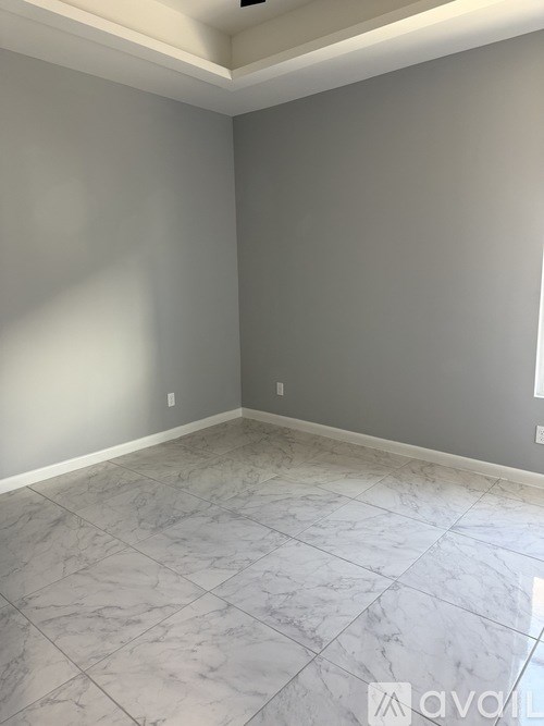A room with grey walls and marble flooring.