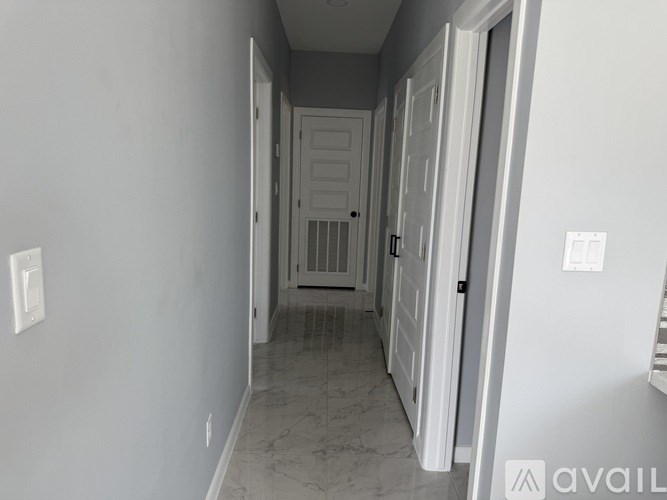 A long hallway with a door at the end.