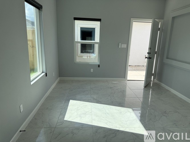 A room with a marble floor and a window.