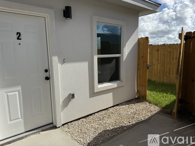 A white door with the number 2 on it is on the left and a window is on the right.