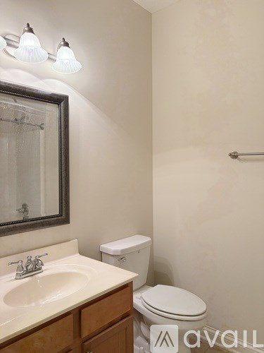A spacious garage with a white door and a flat screen TV mounted on the wall.