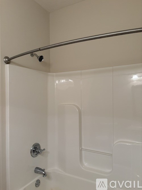 A swimming pool surrounded by a fence and chairs.