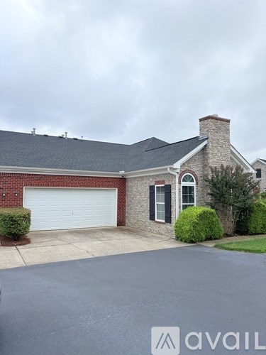 A pool surrounded by a black fence with a lamp post in the foreground.