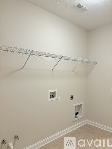 A house with a brick facade and a flag on a pole.