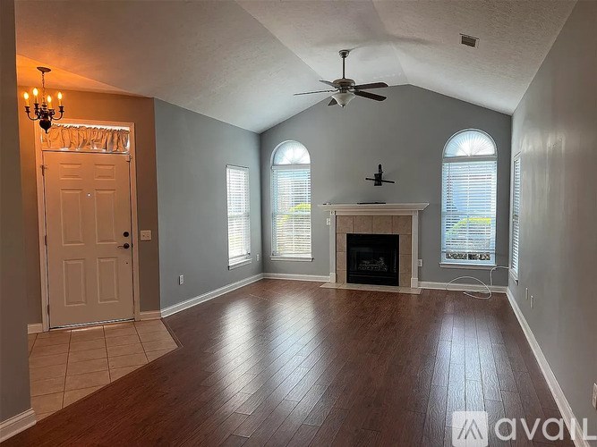 A room with a fireplace and a chandelier.