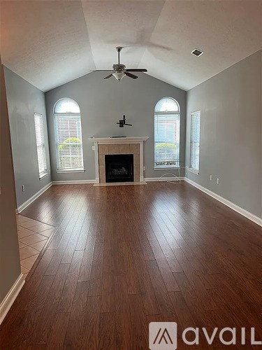 A room with wooden floors and a fireplace.