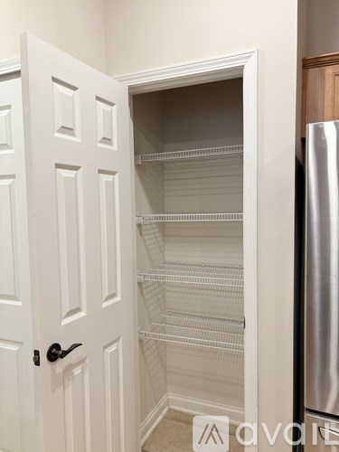A room with a ceiling fan and wood flooring.