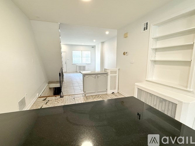 A room with a black table and white walls.