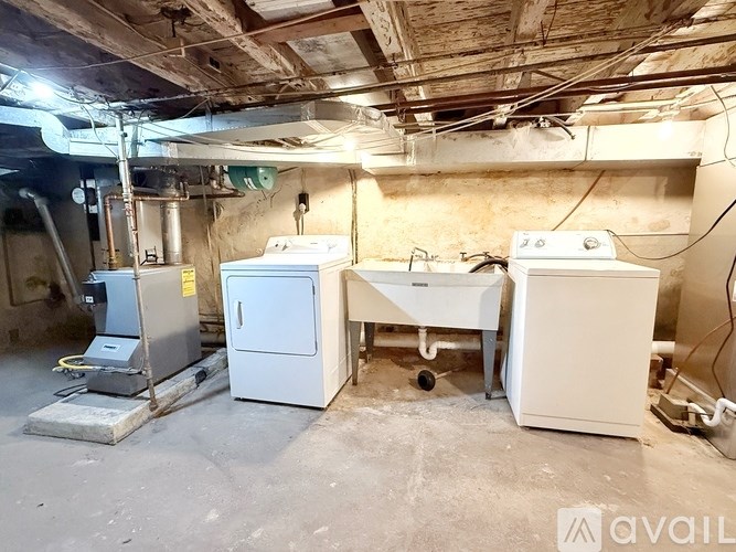 A room with a white fridge, a white freezer, and a white dishwasher.