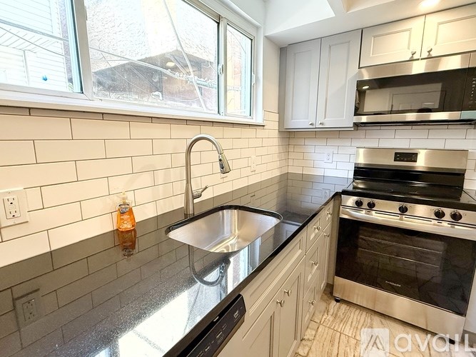 A kitchen with a stainless steel sink and oven.