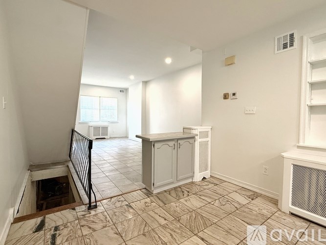 A room with a tiled floor and a window letting in light.