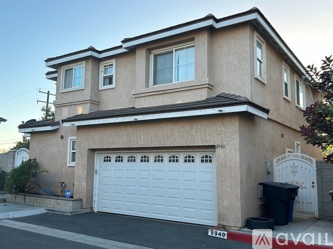 A bathroom with a glass shower door and a white sink.