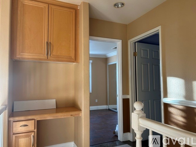 A room with a desk and a cabinet.
