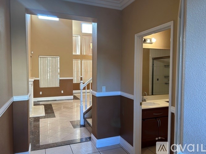 A room with a desk and a computer monitor.