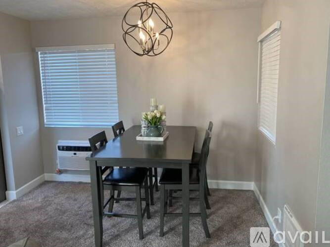 A dining room with a table set for four.
