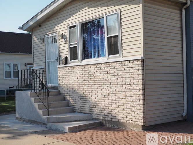 A small house with a white door and a window with curtains.