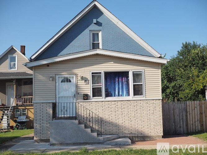 A small house with a blue door and a window with curtains.