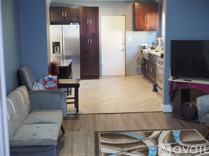 A living room with a grey couch and a television.
