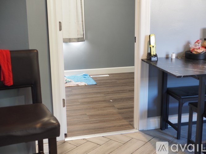 A room with a brown chair and a blue mat on the floor.