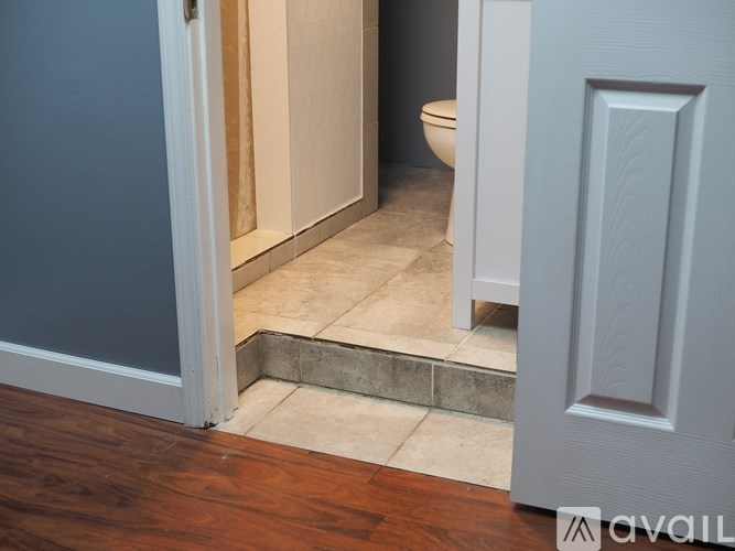 A bathroom with a toilet and a door.