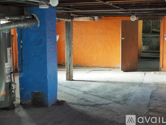 A room with a blue column and orange walls.