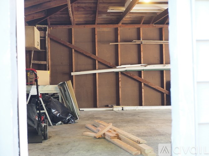 A room under construction with wooden studs and a white door.
