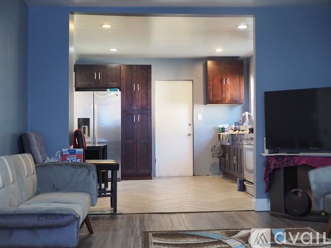 A living room with a grey couch and a television.