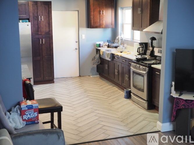 A kitchen with wooden cabinets and a white fridge.