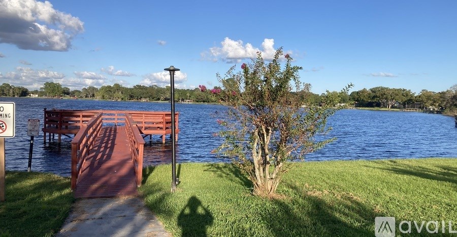 A living room with a red couch and a ceiling fan.