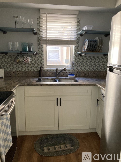 A kitchen with a sink and a window.