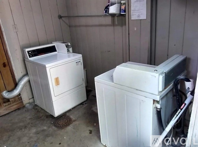 A white washing machine and dryer in a small room.