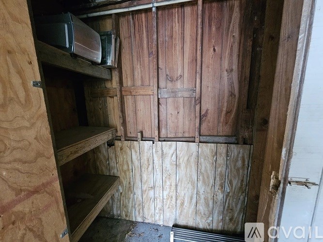 A wooden shelving unit with a white door on the right.