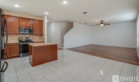 A kitchen with wooden cabinets and a countertop is shown.
