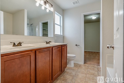 A bathroom with two sinks and a toilet.