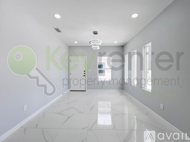 A spacious room with a marble floor and a key-shaped decoration on the wall.