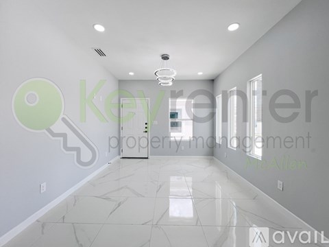A spacious room with a marble floor and a key-shaped decoration on the wall.