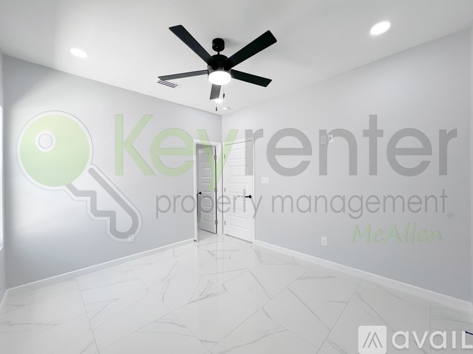 A room with a ceiling fan and a logo on the wall.