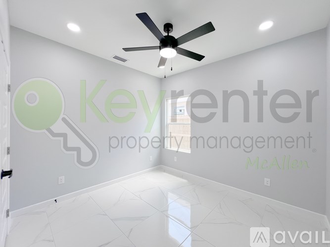 A room with a ceiling fan and a key logo on the wall.