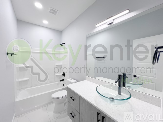 A bathroom with a glass bowl sink and a toilet.