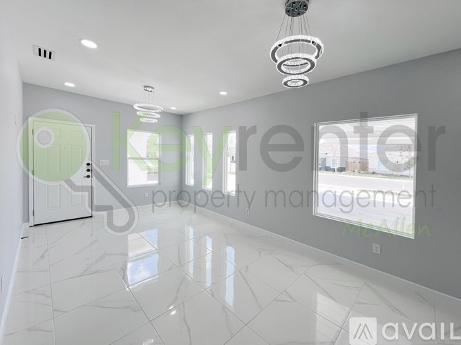 A spacious, well-lit room with a marble floor and a green door.