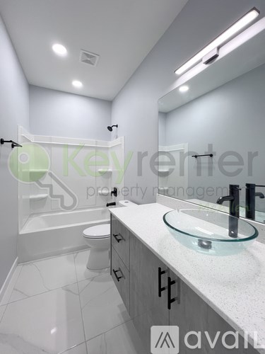 A bathroom with a glass sink and a toilet.