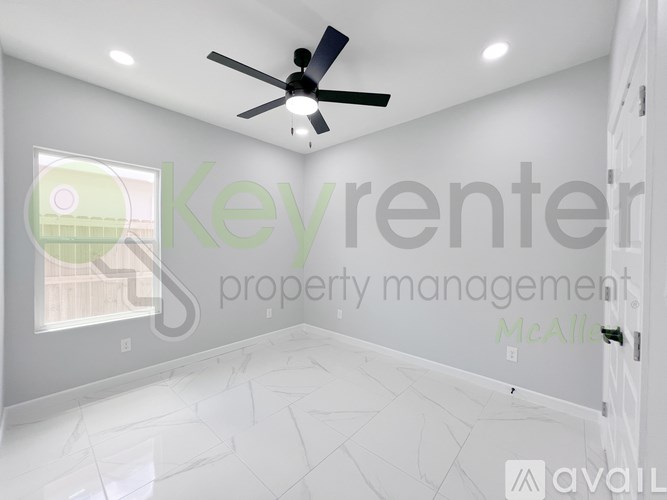 A room with a ceiling fan and a window.