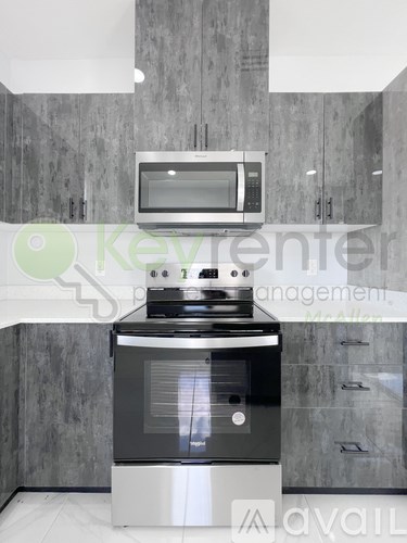 A kitchen with a stove and microwave above it.