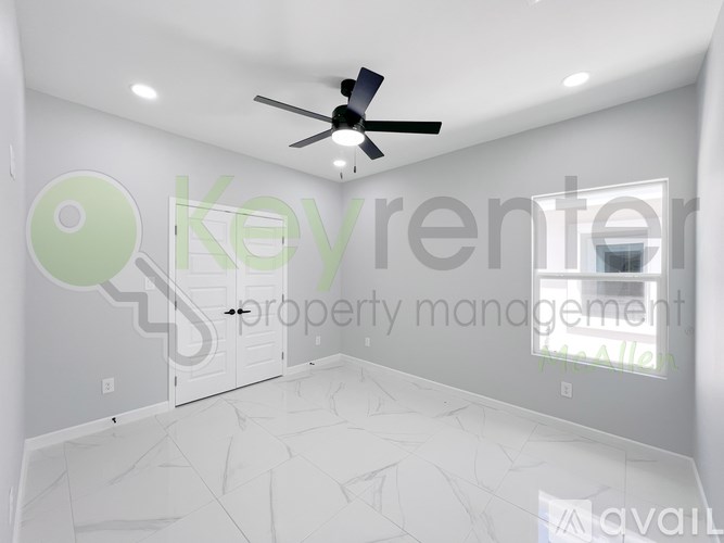 A room with a ceiling fan and a window.