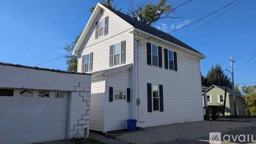 A two-story house with a garage is available for sale.