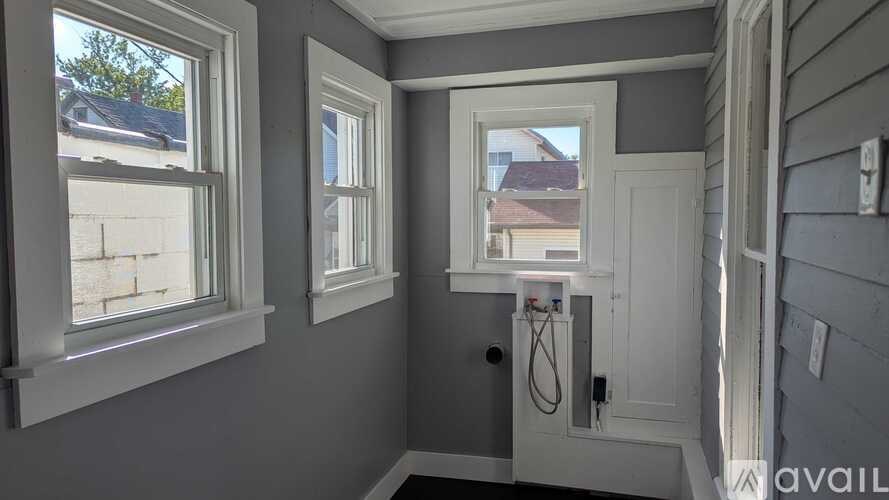 A bathroom with a window and a door.
