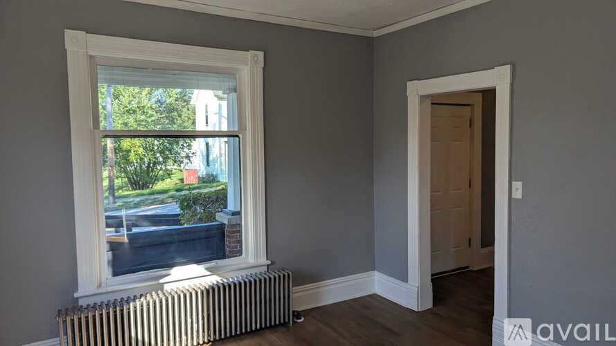 A room with a window and a door.